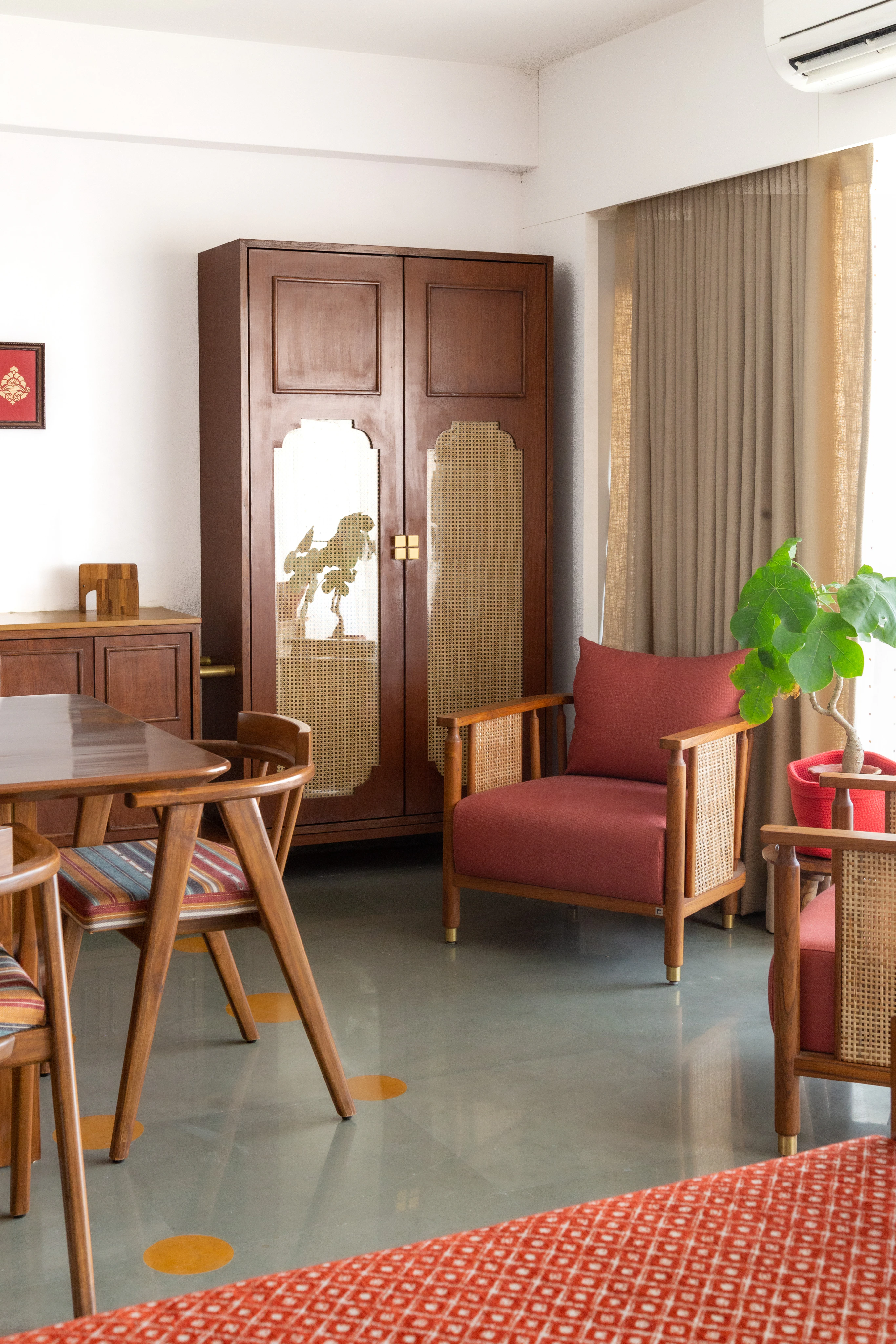 Dining room with cane-inlay cabinetry and artisanal armchairs