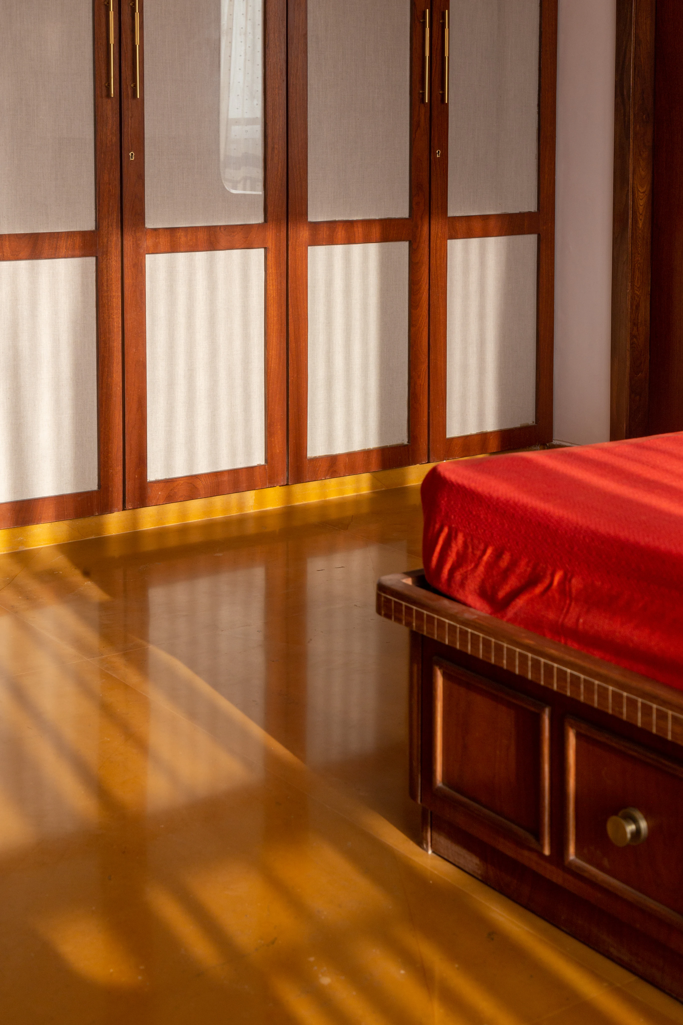 Bedroom with bespoke wardrobes and polished stone flooring