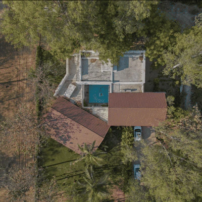 Top-down orthographic aerial view of Asarma layout with central pool and surrounding preserved trees