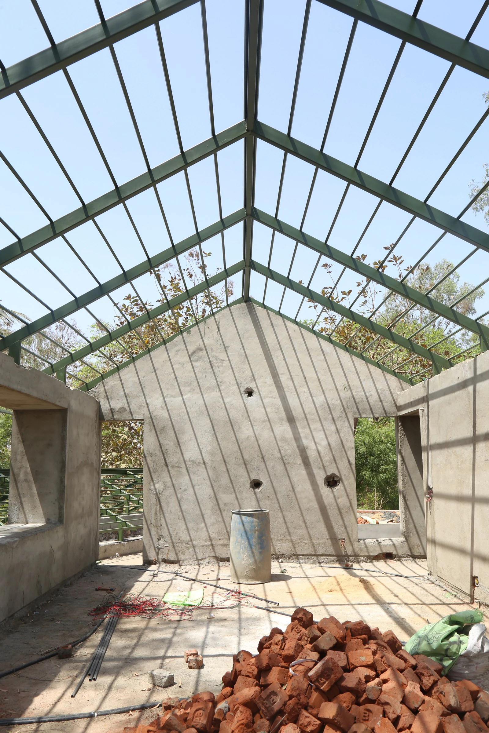Upper pitched roof structural steel trusses framing the Vadodara sky