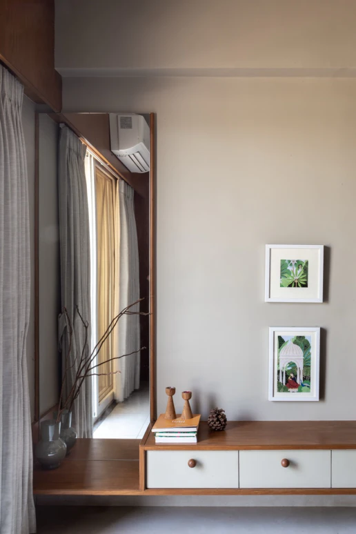 Bedroom with fluted timber headboard accent, pendant lighting, and contemporary artwork