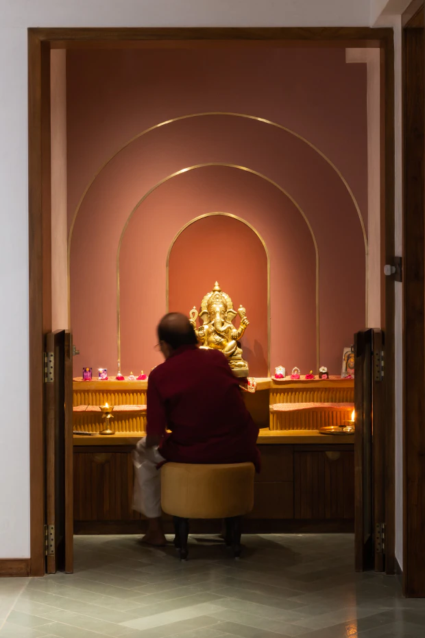 Sanctum mandir with curved niches and artisanal brass trim