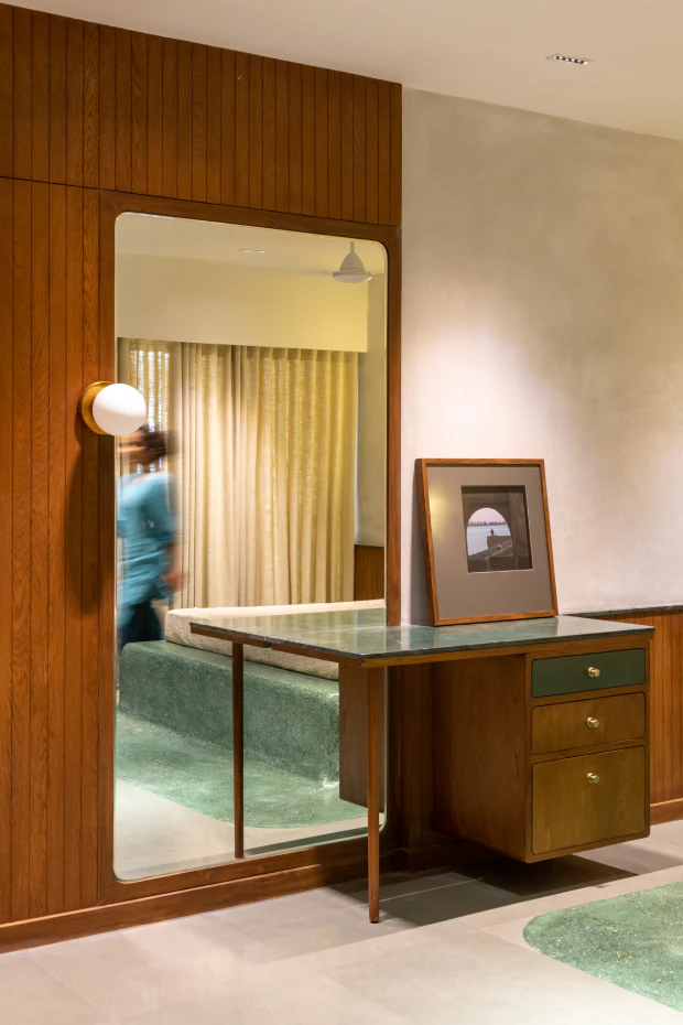 Bedroom dressing vanity with green marble counter and full-height mirror