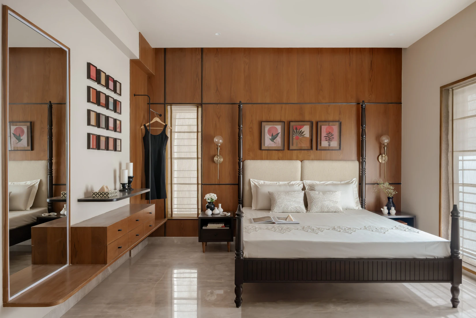 Spacious bedroom suite featuring a dark timber four-poster bed against warm wood wall paneling and a floating vanity dresser with mirror