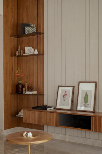 Living room media console with wall-mounted fluted wood cabinet, corner display shelving, and grooved paneling